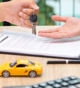 businessman-giving-car-key-loan-agreement-document-with-car-toy