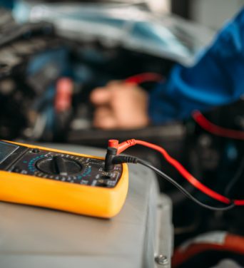 car-repairman-with-multimeter-battery-inspection-auto-service-vehicle-wiring-diagnostic-electrician-occupation