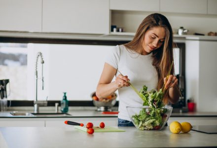 young-woman-making-salad-kitchen (1)